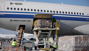 Workers unload boxes of protective face masks from an Air China plane  in Athens, Greece, March 21 (Reuters/Alkis Konstantinidis)