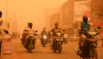 People ride motorcycles during a sandstorm amid the spread of COVID-19 in Ouagadougou, Burkina Faso April 15 (Reuters/Anne Mimault)
