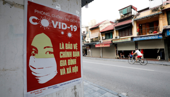 A poster on a street in Hanoi warning about COVID-19 (Reuters/Kham)