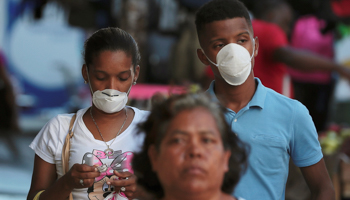 People wear protective masks following an outbreak of COVID-19 in Panama City, Panama, March 12 (Reuters/Erick Marciscano)