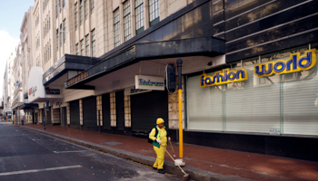 A worker sweeps a deserted shopping street during South Africa's lockdown, Cape Town, April 13, 2020 (Reuters/Mike Hutchings)