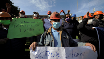 Unemployed coal mine workers hold a sign reading "Solidarity, miners on fight" during a peaceful protest following the outbreak of COVID-19 in Concepcion, Chile, April 22 (Reuters/Jose Luis Saavedra)