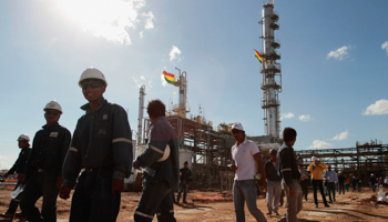 Workers and visitors walk at the Rio Grande natural gas liquid separation plant (Reuters/David Mercado)