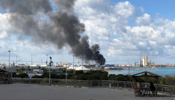 Smoke rises from a Tripoli port after being attacked in February (Reuters/Ahmed Elumami)