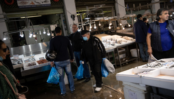 A customer in a face mask walks through a fish market in Athens, May 12 (Reuters/Alkis Konstantinidis)