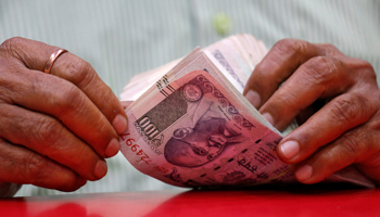A man counting Indian rupee notes (Reuters/Francis Mascarenhas)