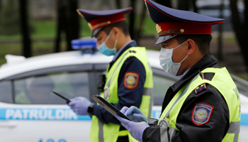 Traffic police at a checkpoint in Almaty set up to enforce movement restrictions (Reuters/Pavel Mikheyev)