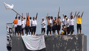 Inmates at the Puraquequara prison in Manaus are seen on the roof during a riot following a COVID-19 outbreak, May 2 (Reuters/Bruno Kelly)