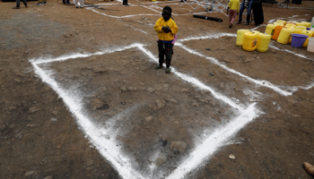 A boy stands in a social distancing marker at a free water distribution programme in the Kibera slums of Nairobi, Kenya, May 22 (Reuters/Baz Ratner)