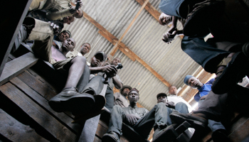 Mine workers sit around a pit in northern Tanzania (Reuters/Antony Njuguna)