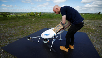 A drone operator from Manna Aero loads up essential household and medical supplies for delivery, following the COVID-19 outbreak, in the village of Moneygall, Ireland May 8 (Reuters/Jason Cairnduff)