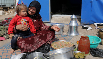 An internally displaced woman preparing food in Aleppo province (Reuters/Khalil Ashawi)