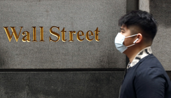 A man walks on Wall Street (Reuters/Lucas Jackson)