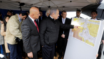 Prime Minister Binyamin Netanyahu consults a map of the area during a visit to the West Bank settlement of Ariel (Reuters/Sebastian Scheiner)