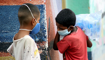 Children wear face masks near the Venezuela-Colombia border after the Colombian government decided to close the Simon Bolivar international bridge as a preventive measure in response to the COVID-19 crisis. San Antonio, Tachira, Venezuela, March 14 (Reuters/Carlos Eduardo Ramirez)