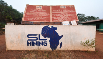 A signboard warning visitors that removing any material from SL Mining’s iron ore mine in Marampa is prohibited by international tribunal, Sierra Leone, February 18 (Reuters/Cooper Inveen.)
