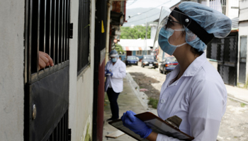Health workers convince residents to get tested for COVID-19, in San Jose, Costa Rica June 26 (Reuters/Juan Carlos Ulate)