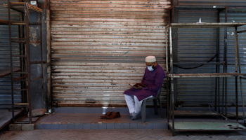 A shopkeeper outside his shuttered shop in Karachi amid the COVID-19 crisis (Reuters/Akhtar Soomro)