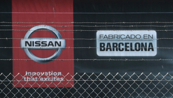 The logo of Nissan is seen through a fence at a Nissan factory at Zona Franca during the COVID-19 outbreak in Barcelona, May 26 (Reuters/Albert Gea)