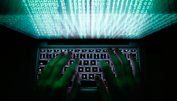 A man typing on his computer in Warsaw (Reuters/Kacper Pempel)