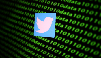 The Twitter logo against a background of binary cyber codes (Reuters/Dado Ruvic)