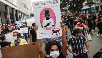 A protester with a poster of 14-year-old Joao Pedro, killed in a police anti-drugs raid (Reuters/Ricardo Moraes)