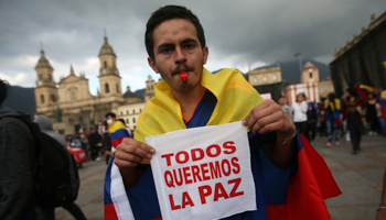 A protester holds a placard during a demonstration in Bogota, Colombia. The placard reads: "We all want peace" (Reuters/Luisa Gonzalez)