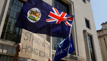 Protesters wave a colonial-era Hong Kong flag outside China's embassy in London (Reuters/John Sibley)