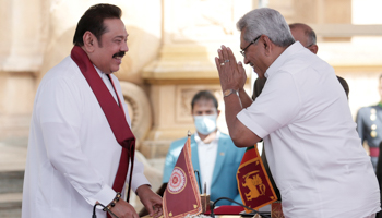 President Gotabaya Rajapaksa (right) gesturing to his brother, Prime Minister Mahinda Rajapaksa (left), at Mahinda’s swearing-in ceremony last week (Reuters/Dinuka Liyanawatte)
