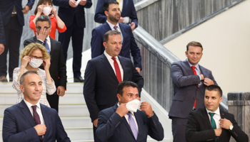 Zoran Zaev (bottom, centre) puts on facemask at group photo of new ministers, Skopje, August 30 (Reuters/Ognen Teofilovski)