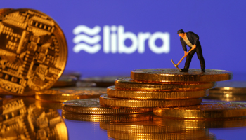 A small toy figure stands on representations of virtual currency in front of the Libra logo (Reuters/Dado Ruvic/Illustration)