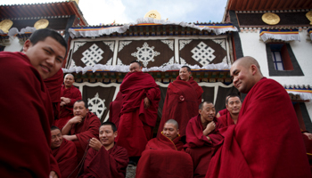 Buddhist monks outside a prayer hall in the largely ethnic Tibetan town of Rebkong, Qinghai province (Reuters/Thomas Peter)