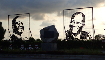 Portraits of former Ivorian President Henri Konan Bedie (l) and current President Alassane Ouattara (r) at the entrance of the Henri Konan Bedie Bridge, Abidjan. November, 30, 2019 (Shutterstock/Xavier Boulenger)