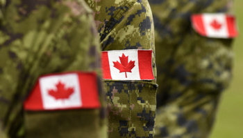 Canada's flag displayed on military uniforms (Bumble Dee/Shutterstock)