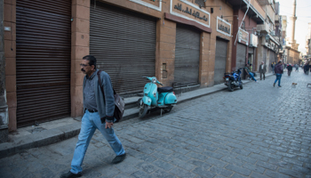 A man walks along a street of Cairo shops closed due to COVID-19 restrictions (Mohamed Hossam/EPA-EFE/Shutterstock)