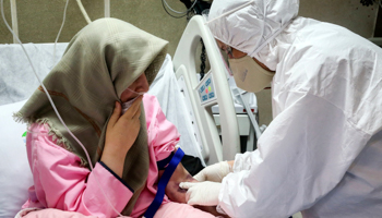 A medic treats a COVID-19 patient in Tehran (Mohammad Hasan Zarifmanesh/AP/Shutterstock)