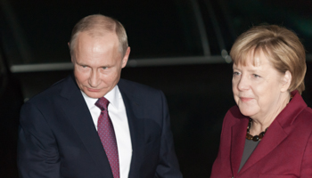 Russian President Vladimir Putin and German Chancellor Angela Merkel (Shutterstock/photocosmos1)