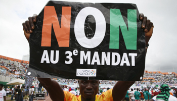 A man holds a sign reading 'No to the 3rd term' during an opposition rally at the Felix Houphouet-Boigny stadium, Abidjan, October 10 (Legan Koula/EPA-EFE/Shutterstock)