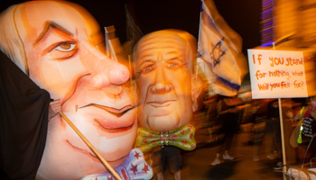 Protesters masked as Israel's Prime Minister Binyamin Netanyahu and Defence Minister Benny Gantz outside the prime minister’s residence in Jerusalem (Ariel Schalit/AP/Shutterstock)