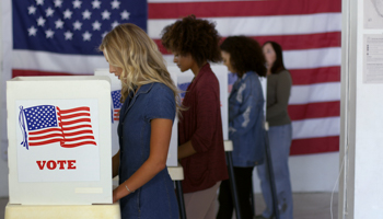 Voters casting ballots (Shutterstock / vesperstock)