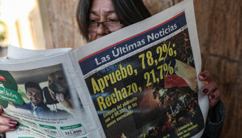 A woman reading Monday's newspaper with the referendum results (Esteban Felix/AP/Shutterstock)