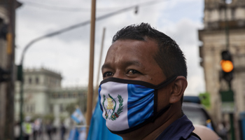 A street vendor wears a protective face mask with the colours of the Guatemalan flag, Guatemala City, Guatemala(Moises Castillo/AP/Shutterstock)