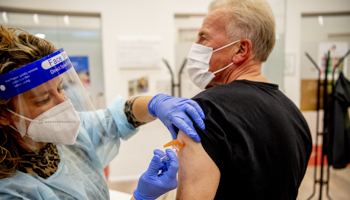 Man receives vaccine, Netherlands, October 2020 (Robin Utrecht/Shutterstock)