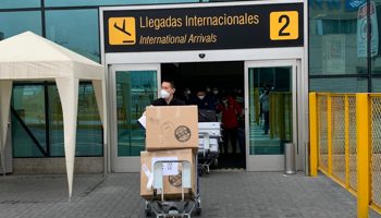 Chinese medical staff arrive at Lima airport with experimental COVID-19 vaccines (Cesar Barreto/AP/Shutterstock)