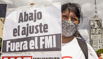 A protester in Buenos Aires with a sign saying "No more adjustment. IMF out." (Roberto Almeida Aveledo/ZUMA Wire/Shutterstock)