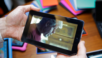 A user trying an affordable tablet (Eric Risberg/AP/Shutterstock)