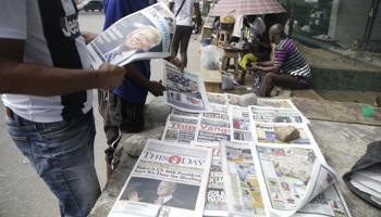 People read newspapers reporting on the victory of Joe Biden in the US presidential election, Lagos, Nigeria, November 8, 2020 (Sunday Alamba/AP/Shutterstock)