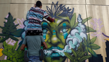 An artist paints a mural during a protest calling for the legalisation of marijuana, in Mexico City, 2019 (Rebecca Blackwell/AP/Shutterstock)