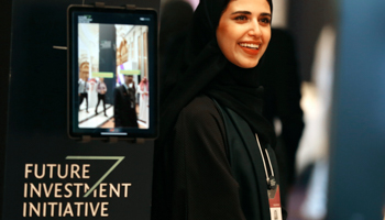 An organiser welcomes participants at the Saudi Public Investment Fund’s 2019 Future Investment Initiative forum (Amr Nabil/AP/Shutterstock)
