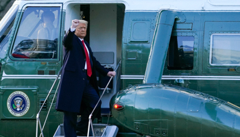 Donald Trump gestures as he boards Marine One on the South Lawn of the White House, 20 January (Alex Brandon/AP/Shutterstock)